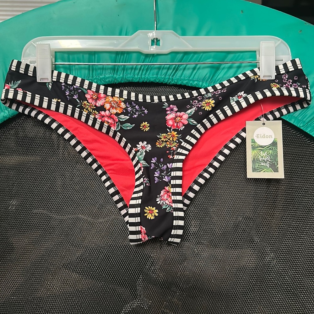Low rise bikini bottom. Ruched back. Size Medium. New with tags. Black & white